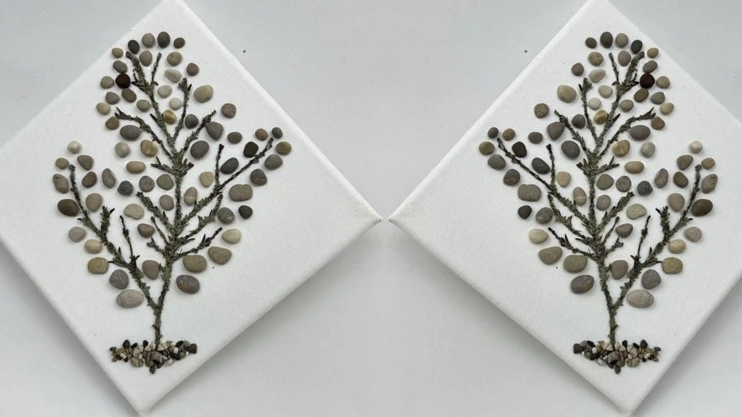 Two pebble-and-twig tree artworks on white canvases, arranged side by side in a mirrored display.